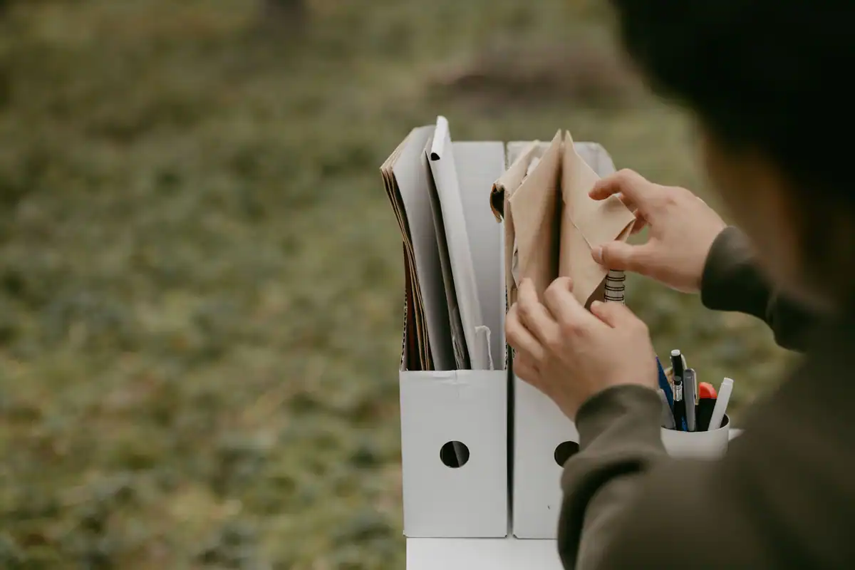 Persoană care caută în dosare un extras de carte funciară pentru autentificare